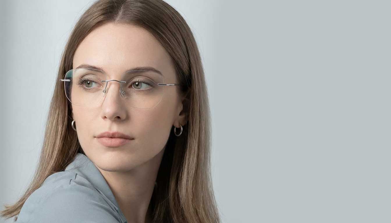 Woman wearing lightweight rimless titanium eyeglasses for daily comfort
